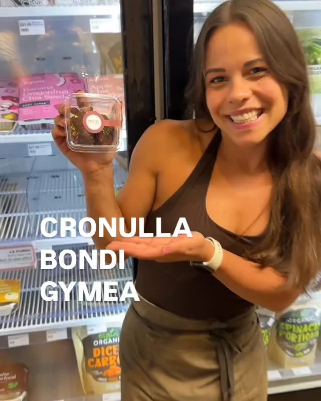 A team member holding an MMMORE treat